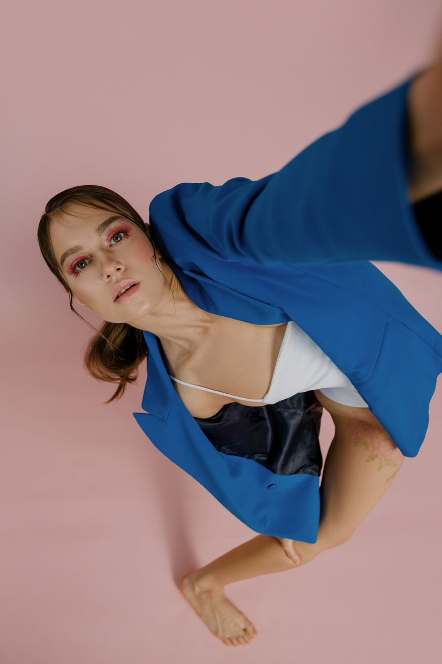 A Woman in Blue Blazer Taking Selfie