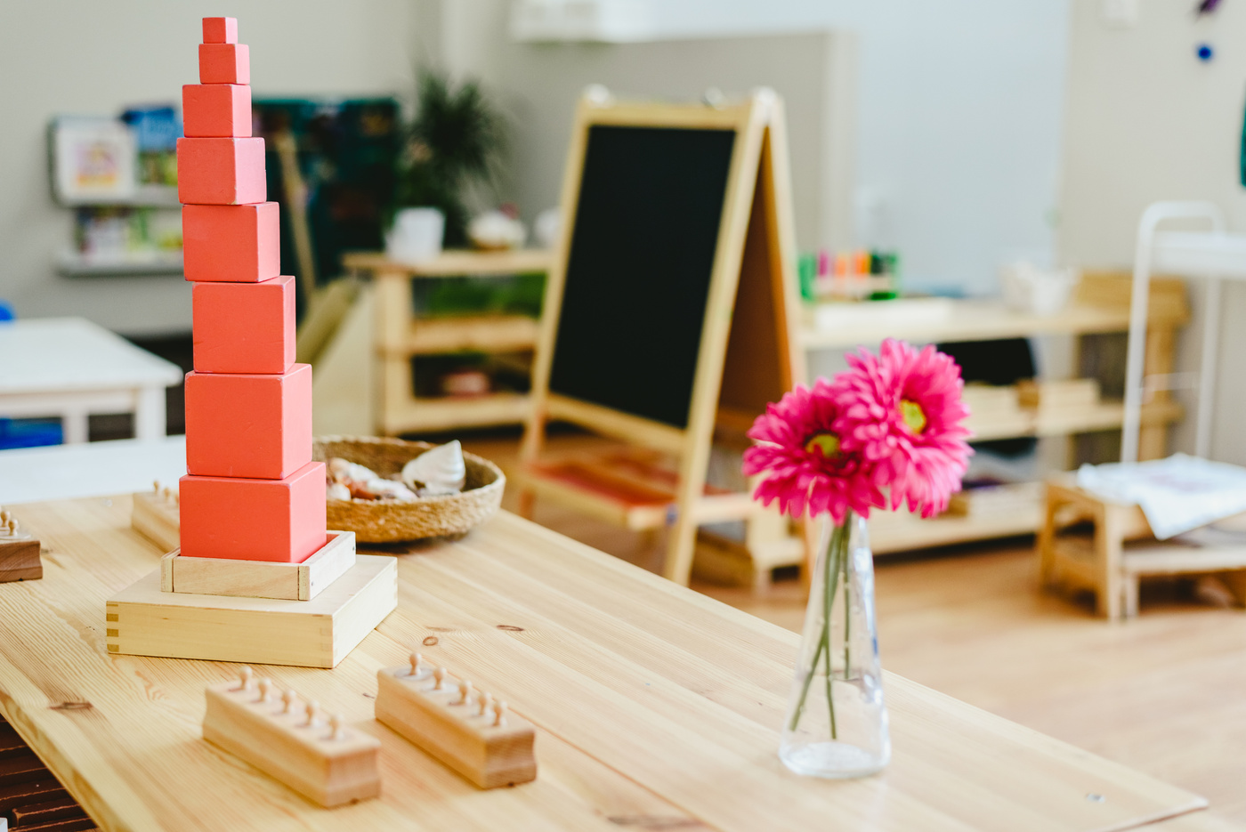 Pink tower in montessori classroom with blackboard